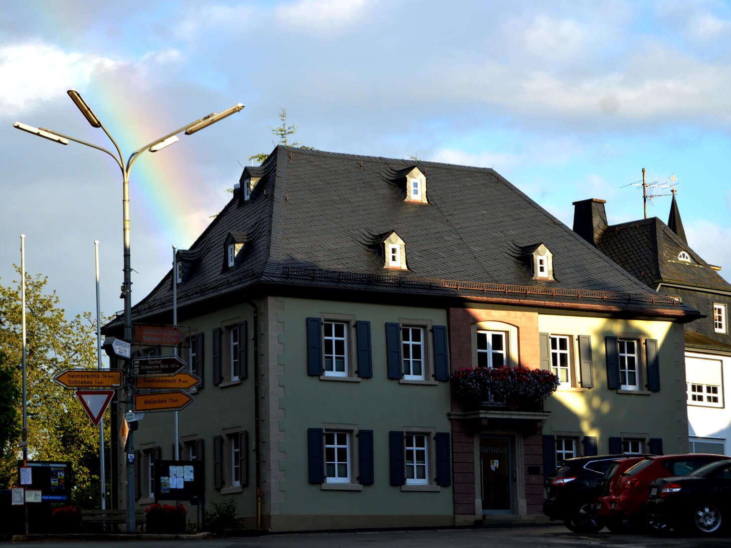 Rathaus Presseck mit Regenbogen und blauer Himmer